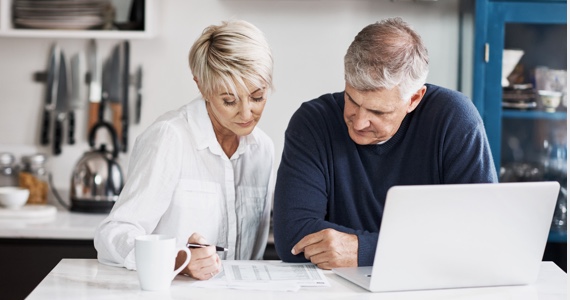 Couple regarde un document sur un comptoir de cuisine