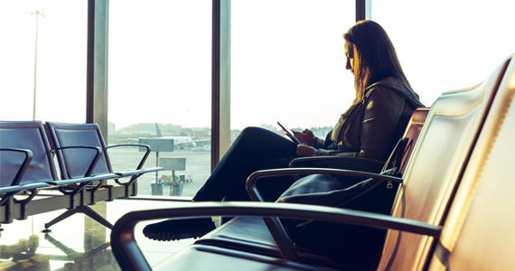 Femme à l'aéroport regarde son téléphone