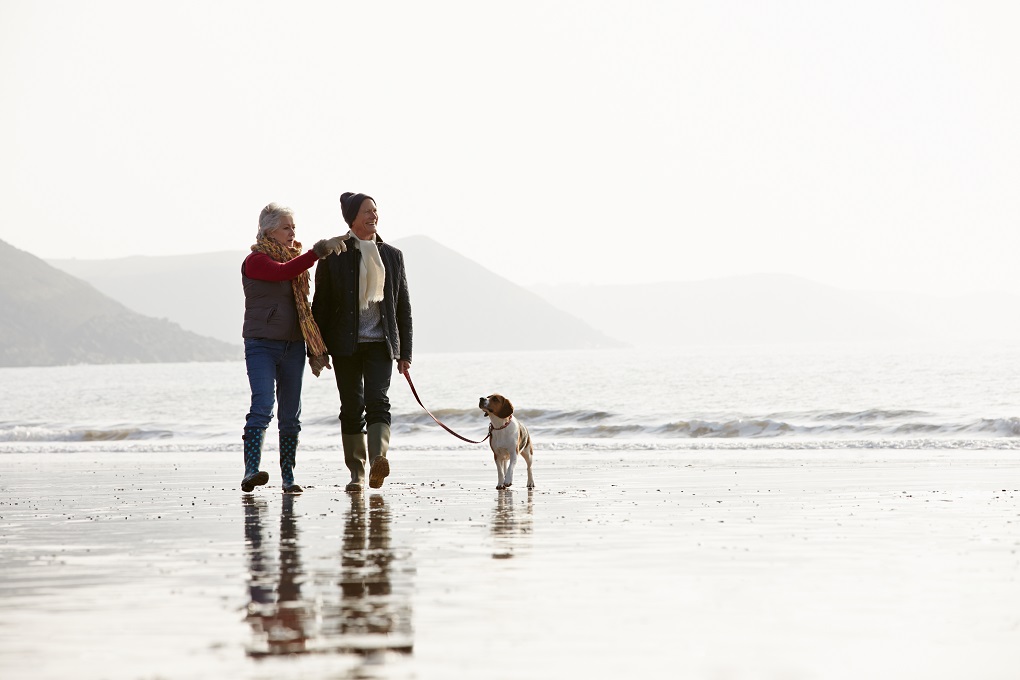 couple retraité qui marche sur une plage