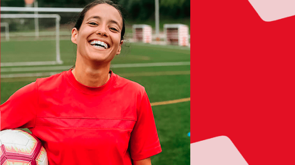 Photo d’une femme souriante sur un terrain de soccer avec le logo Banque Nationale
